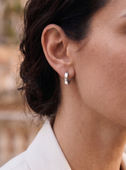 PT950 platinum huggie hoop earring worn by a female model
