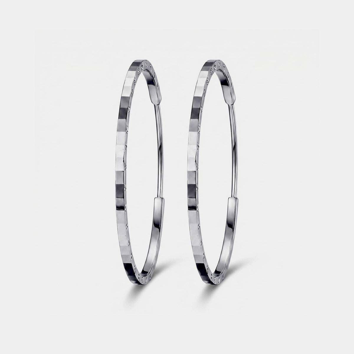 Front view of solid PT950 diamond-cut platinum hoop earrings