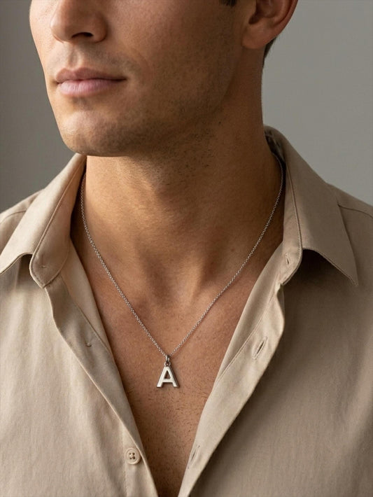 Man wearing platinum letter A initial pendant with beige shirt
