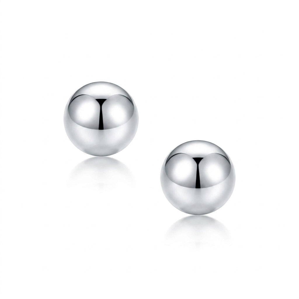 A pair of polished platoinum spherical stud earrings on a clean white background with soft reflections below.
