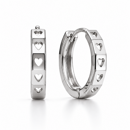 Pair of PT950 platinum huggie earrings with heart-shaped cut-outs and polished facets on a white background.