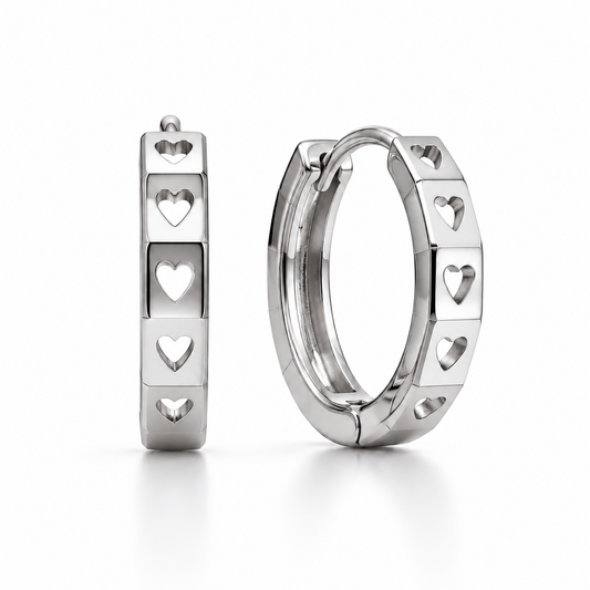 Pair of PT950 platinum huggie earrings with heart-shaped cut-outs and polished facets on a white background.