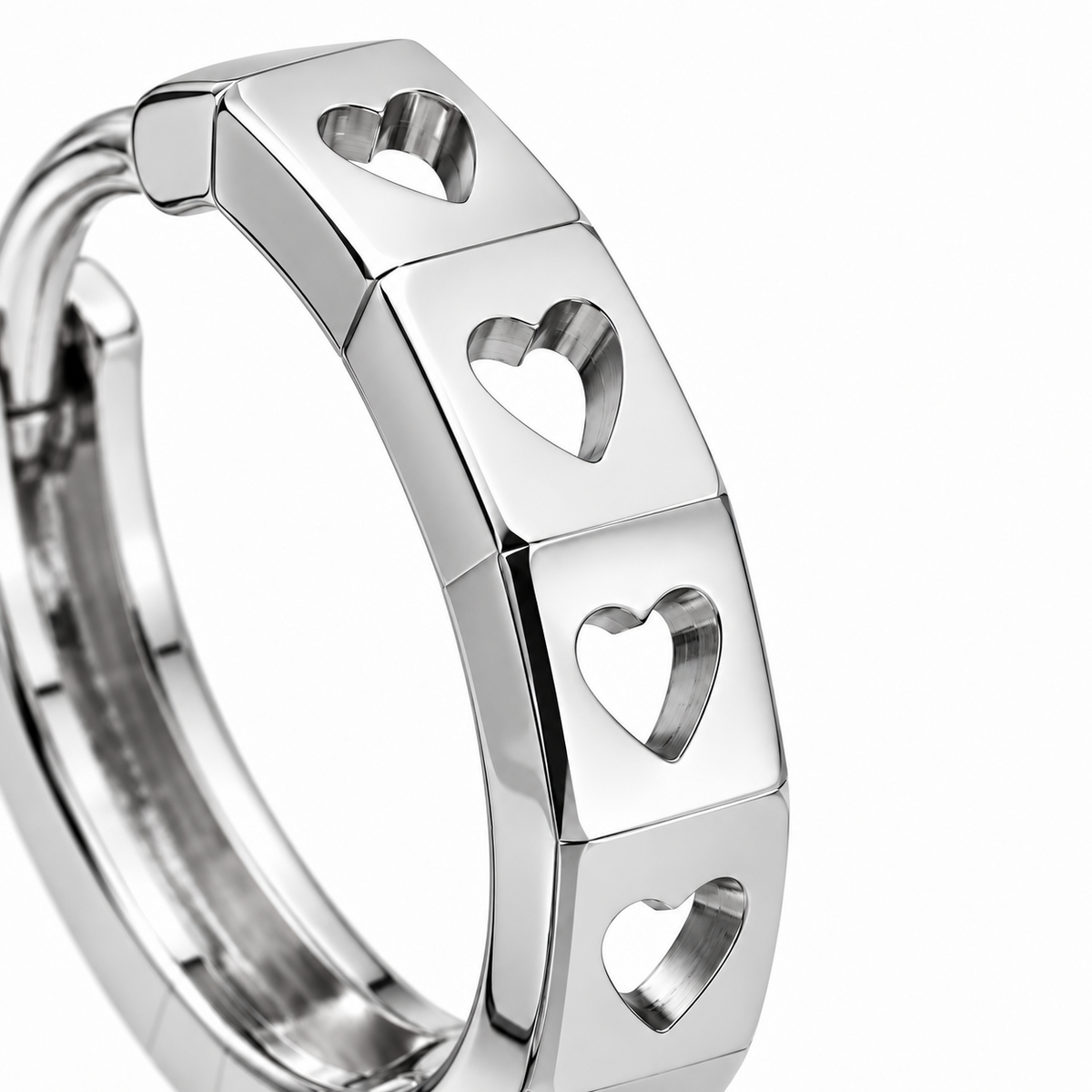 Close-up of heart-shaped openings across the flat, polished facets of a PT950 platinum hoop earring.