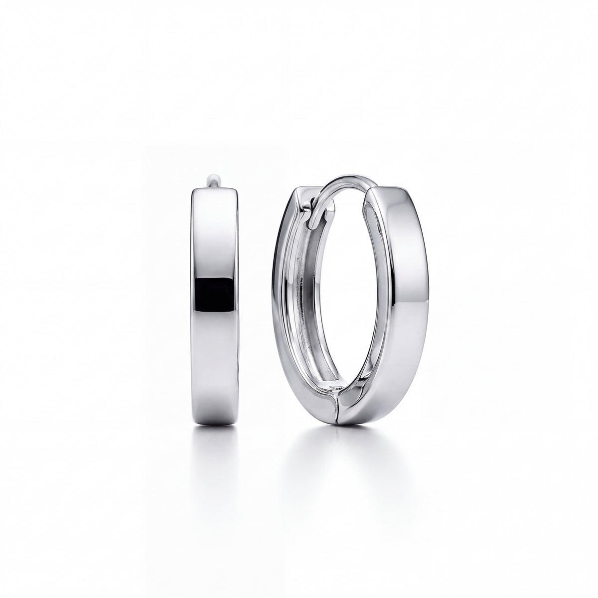 A pair of polished platinum huggie hoop earrings shown on a clean white background, with one earring standing vertically and the other lying horizontally to display both the side profile and the front clasp.