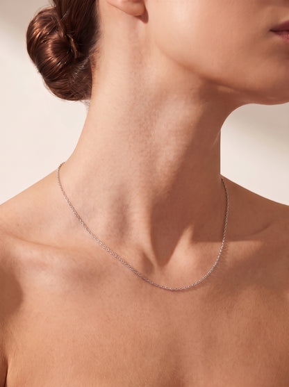 HELIOR 1.2mm platinum cable chain worn alone, side view of the neckline