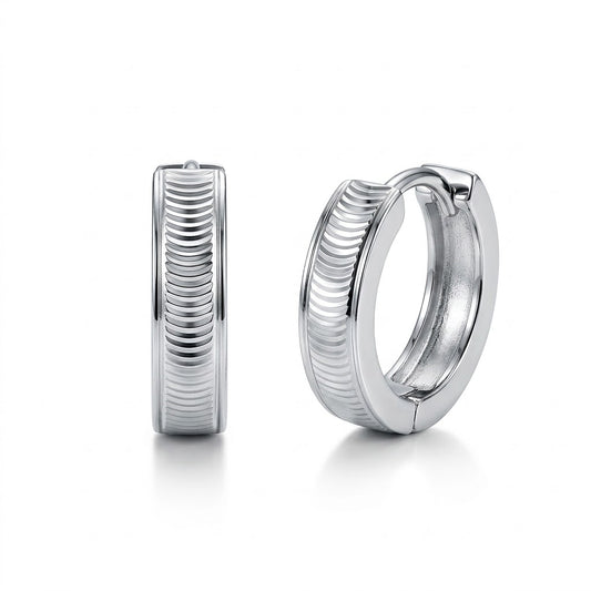 Pair of Vela PT950 platinum textured huggie hoop earrings on a white background