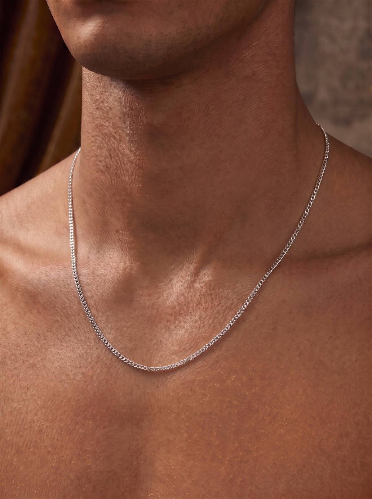 Cadence fine platinum curb chain necklace worn on the upper chest