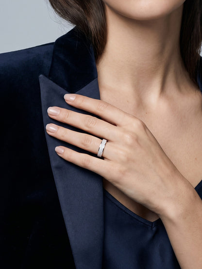 Woman wearing the Dune frosted platinum band, with her hand resting against a navy blazer lapel.
