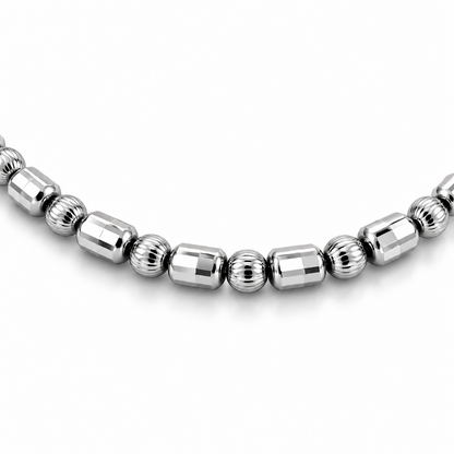 Close-up of HELIOR Orbit platinum bracelet with faceted barrel beads alternating individually with finely ribbed round beads.