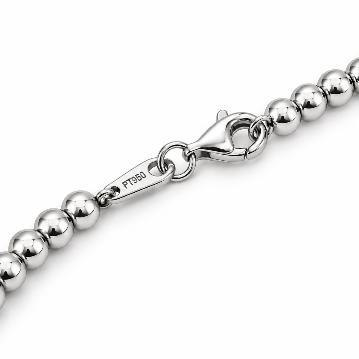 Close-up of the HELIOR Orbit bracelet lobster clasp, polished beads and PT950 marked tag