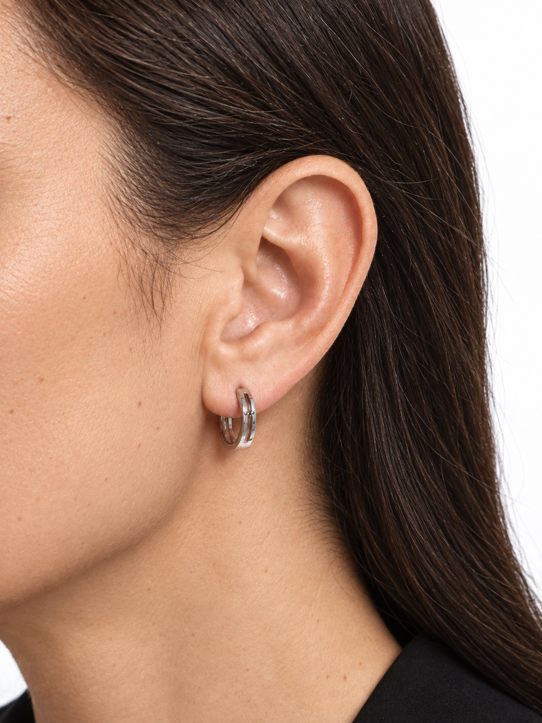 HELIOR platinum openwork hoop earring shown worn on the earlobe