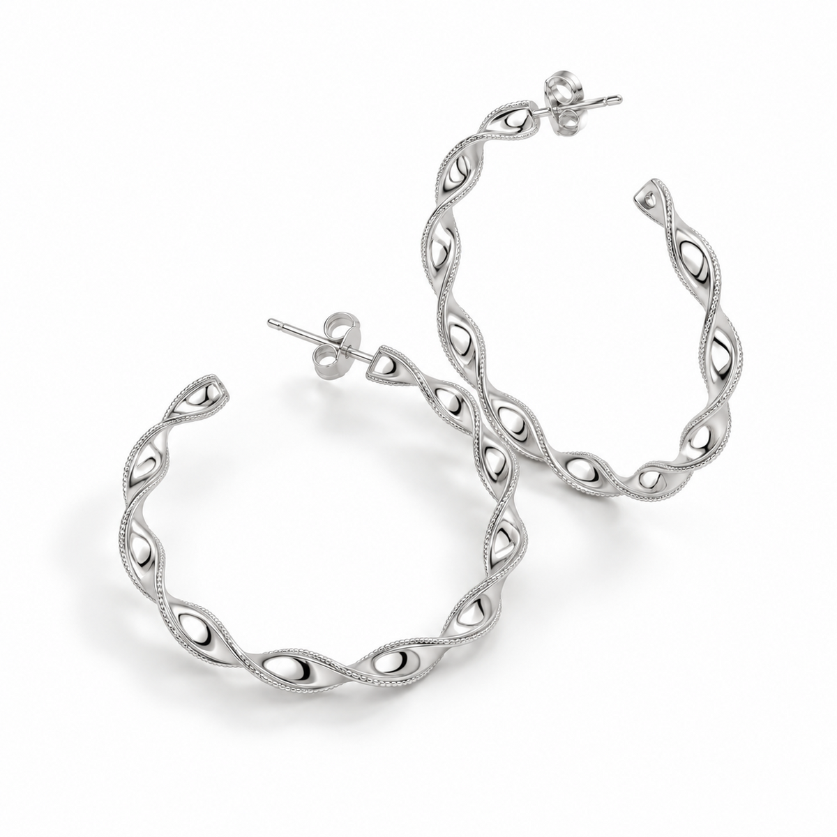 Angled detail of the openwork platinum ribbon twist hoops and butterfly backs