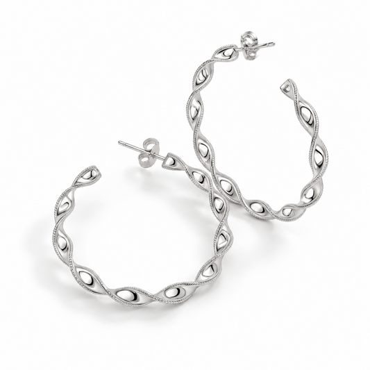 Angled detail of the openwork platinum ribbon twist hoops and butterfly backs