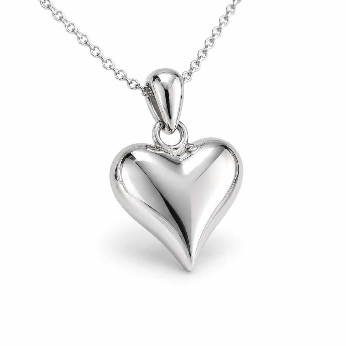 HELIOR PT950 platinum puffed heart pendant at an angle, showing its rounded profile and polished bail; chain not included.