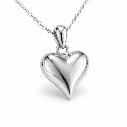 HELIOR PT950 platinum puffed heart pendant at an angle, showing its rounded profile and polished bail; chain not included.
