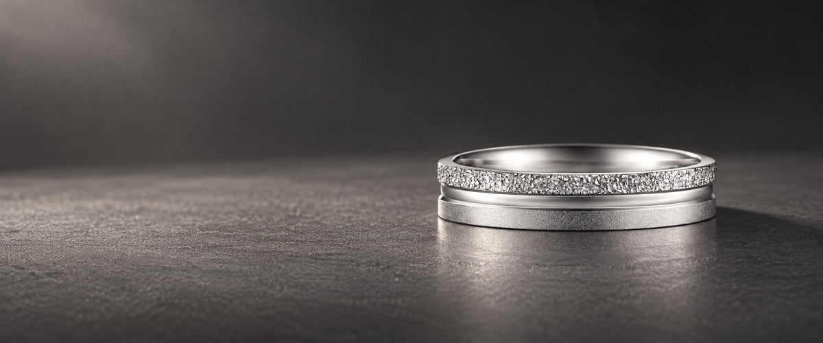 Strata PT950 platinum band with textured, polished and matte finishes on a dark stone surface