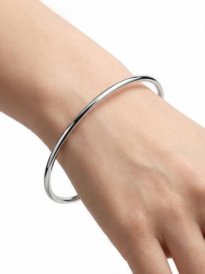 Close wrist view of solid polished platinum bangle