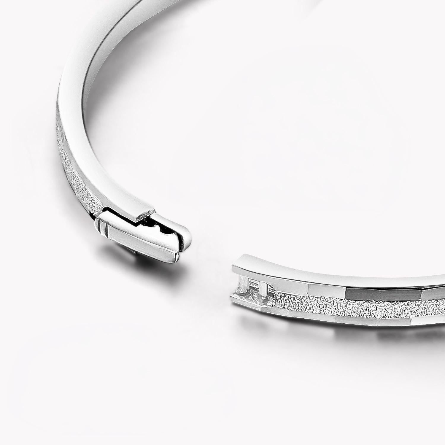 Close-up of hidden clasp on frosted platinum bangle