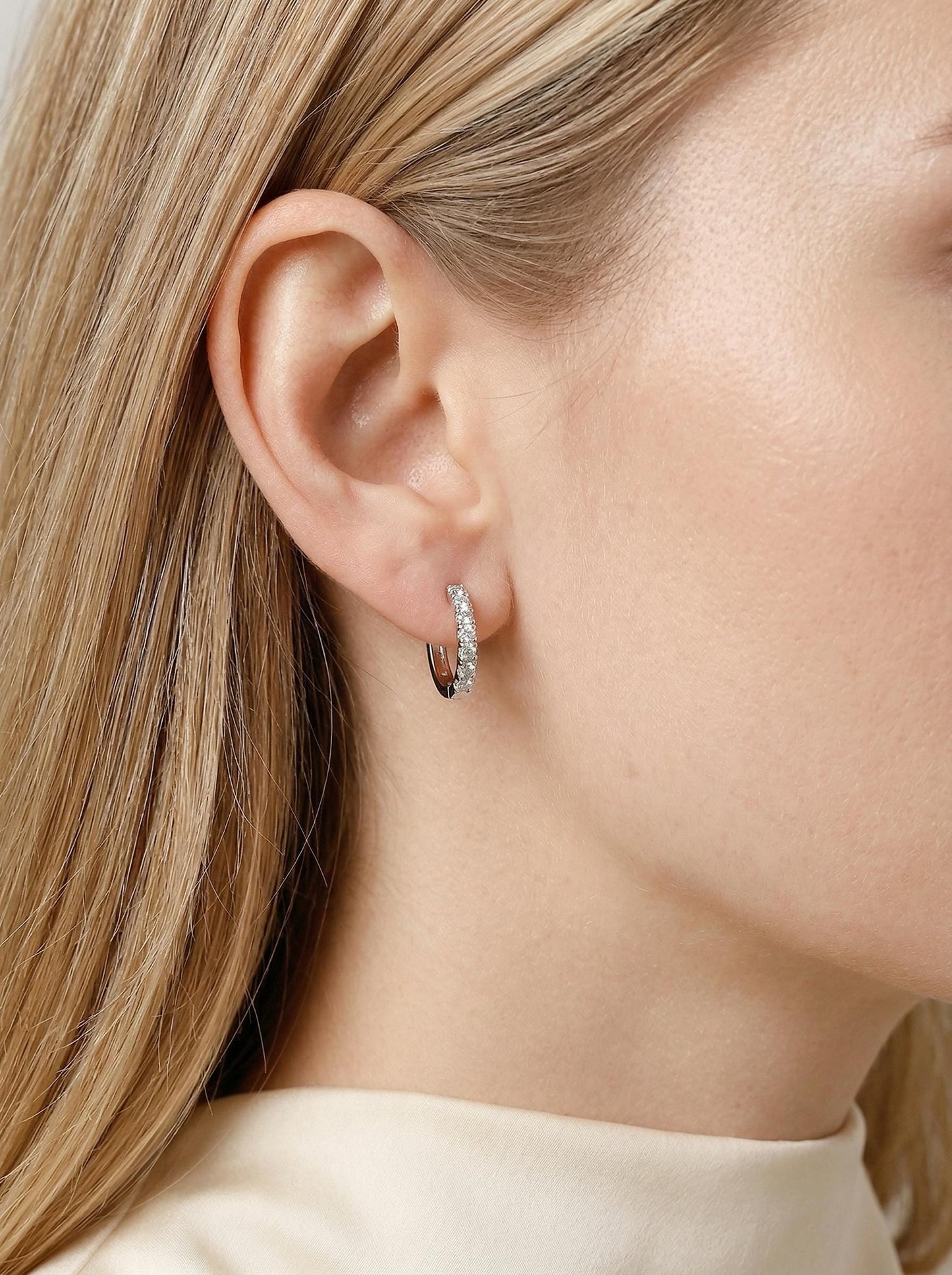 Model wearing PT950 platinum lab diamond huggie earrings