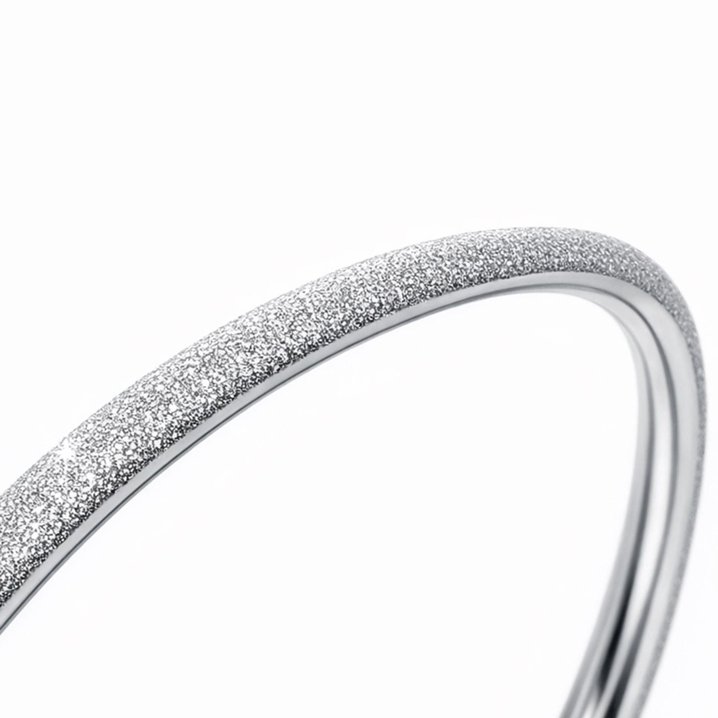 Macro view of fine frosted texture on platinum bangle