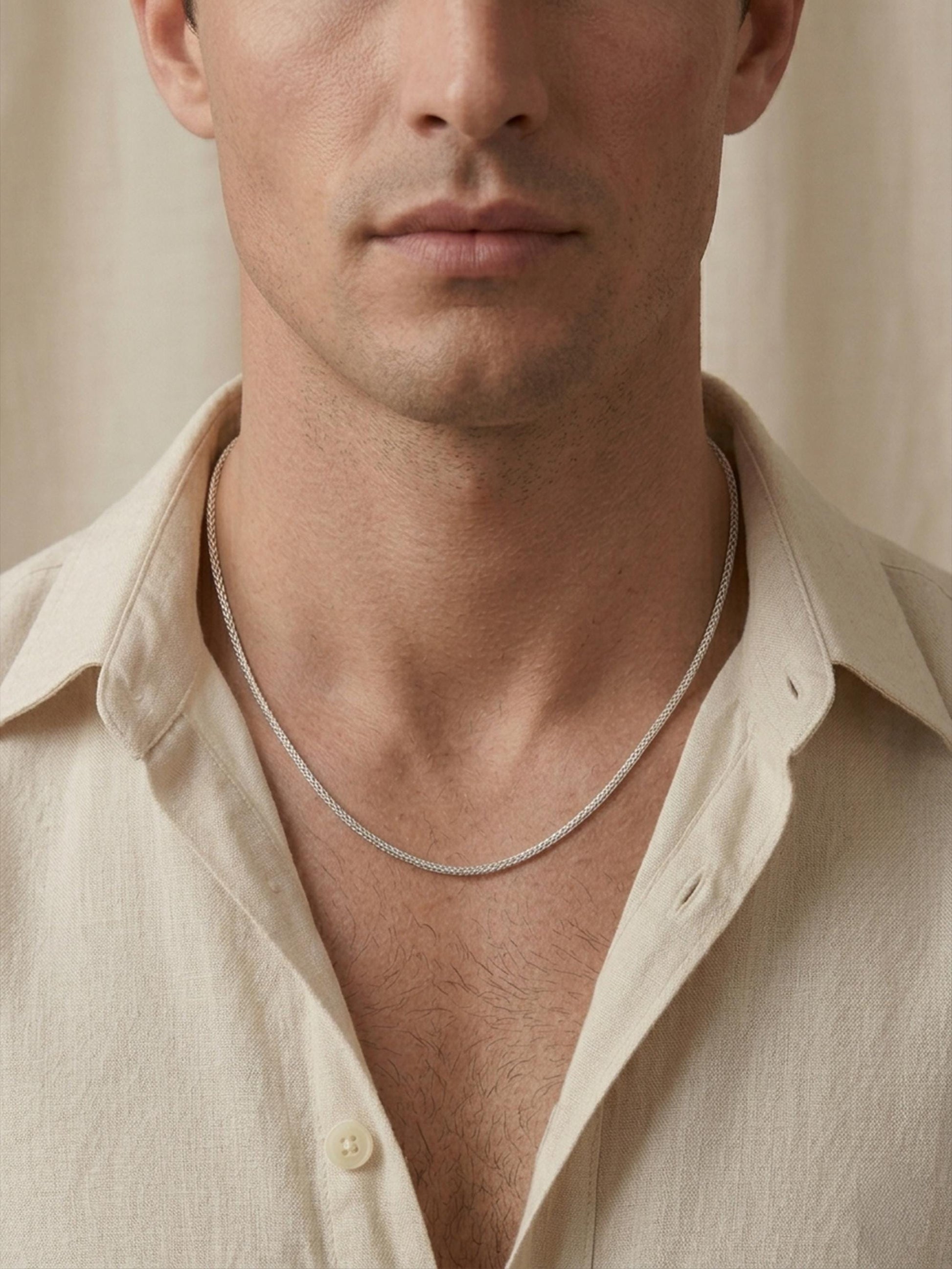 Man wearing solid PT950 platinum foxtail chain with cream shirt