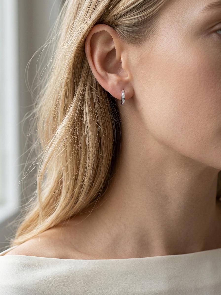 Model wearing PT950 platinum textured 10mm huggie earrings