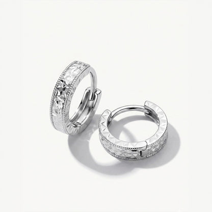 Solid PT950 diamond-cut milgrain huggie hoop earrings on white