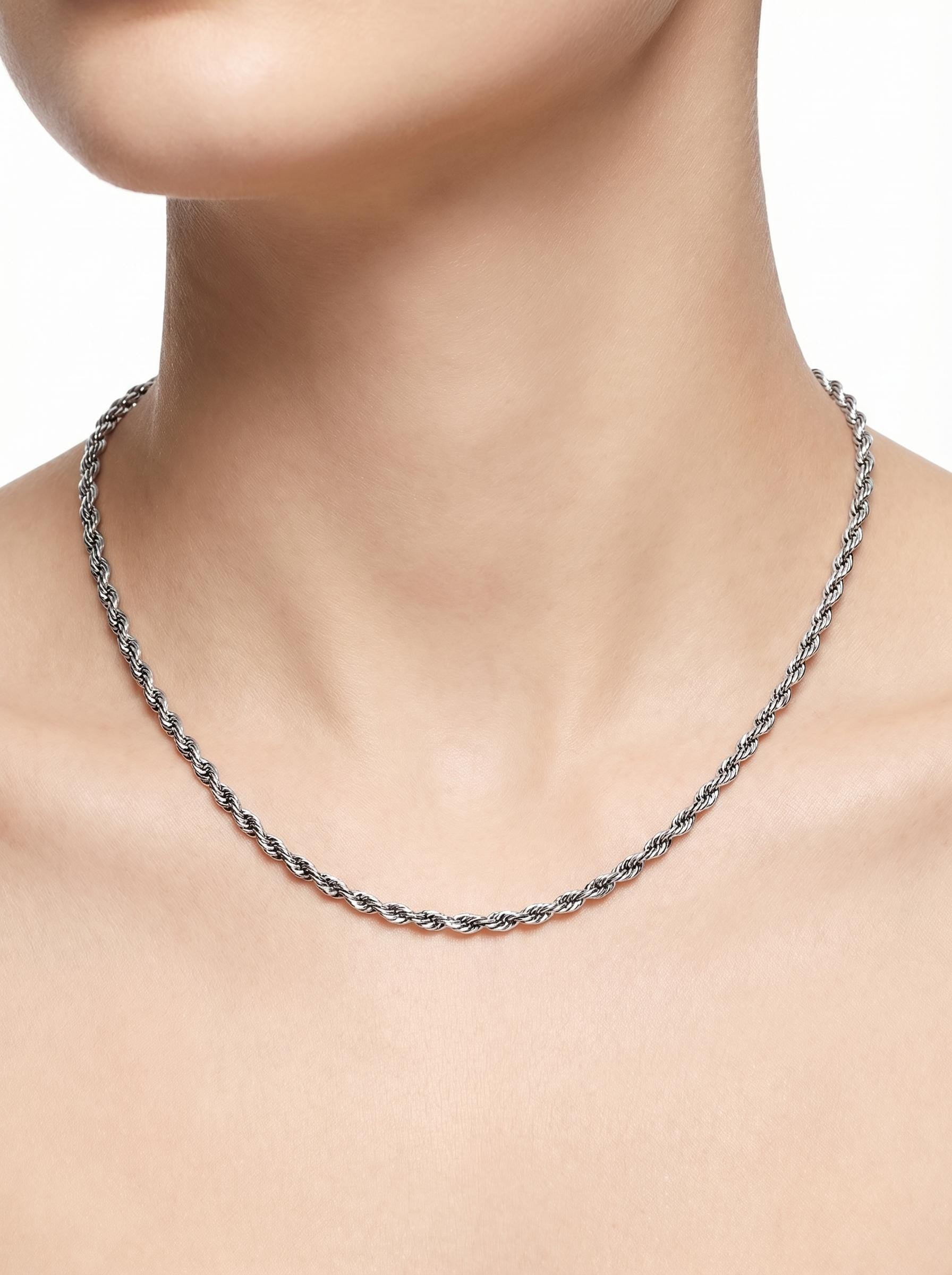 Close neckline view of woman wearing solid platinum rope chain