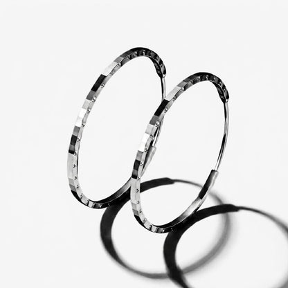 Angled pair of PT950 diamond-cut platinum hoop earrings