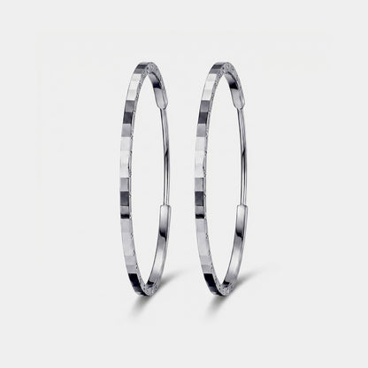 Front view of solid PT950 diamond-cut platinum hoop earrings