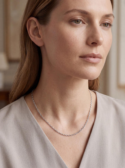 Woman wearing solid platinum elongated-link cable chain necklace