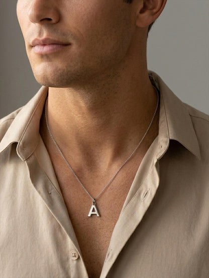 Man wearing platinum letter A initial pendant with beige shirt