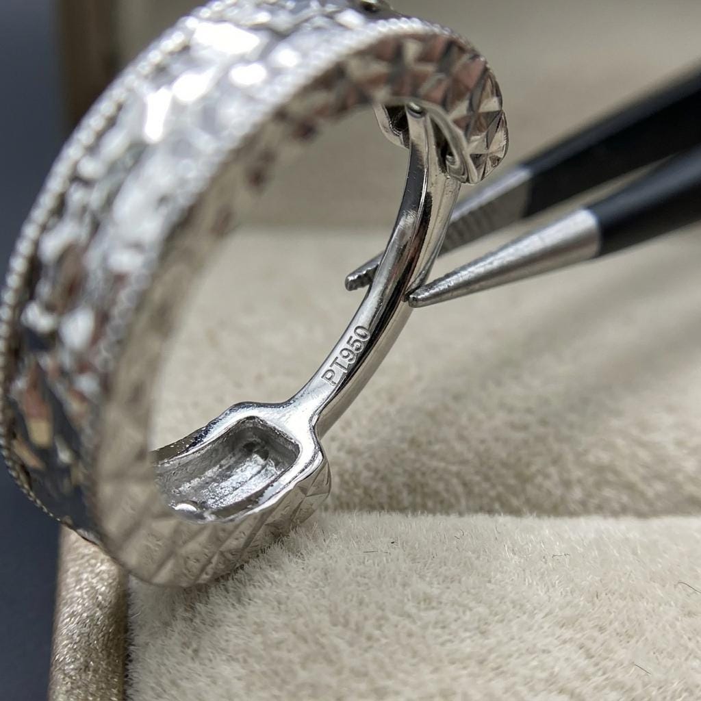 PT950 stamp and hinged clasp inside a diamond-cut huggie hoop