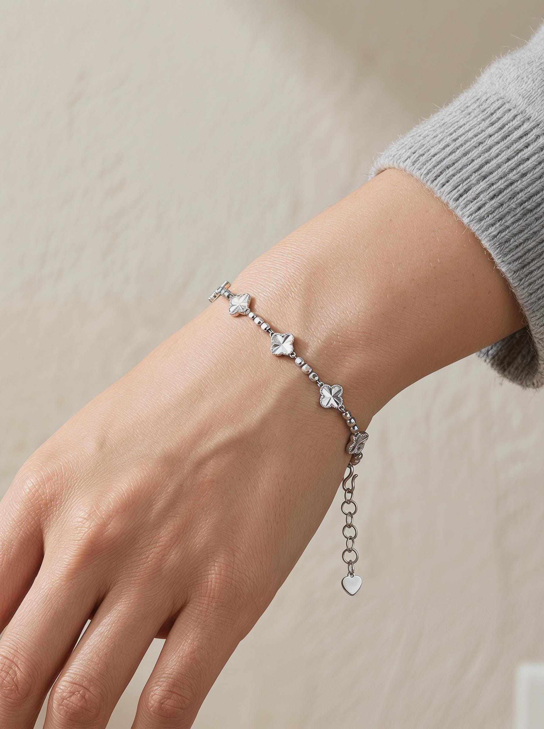 Woman wearing platinum clover and faceted bead bracelet
