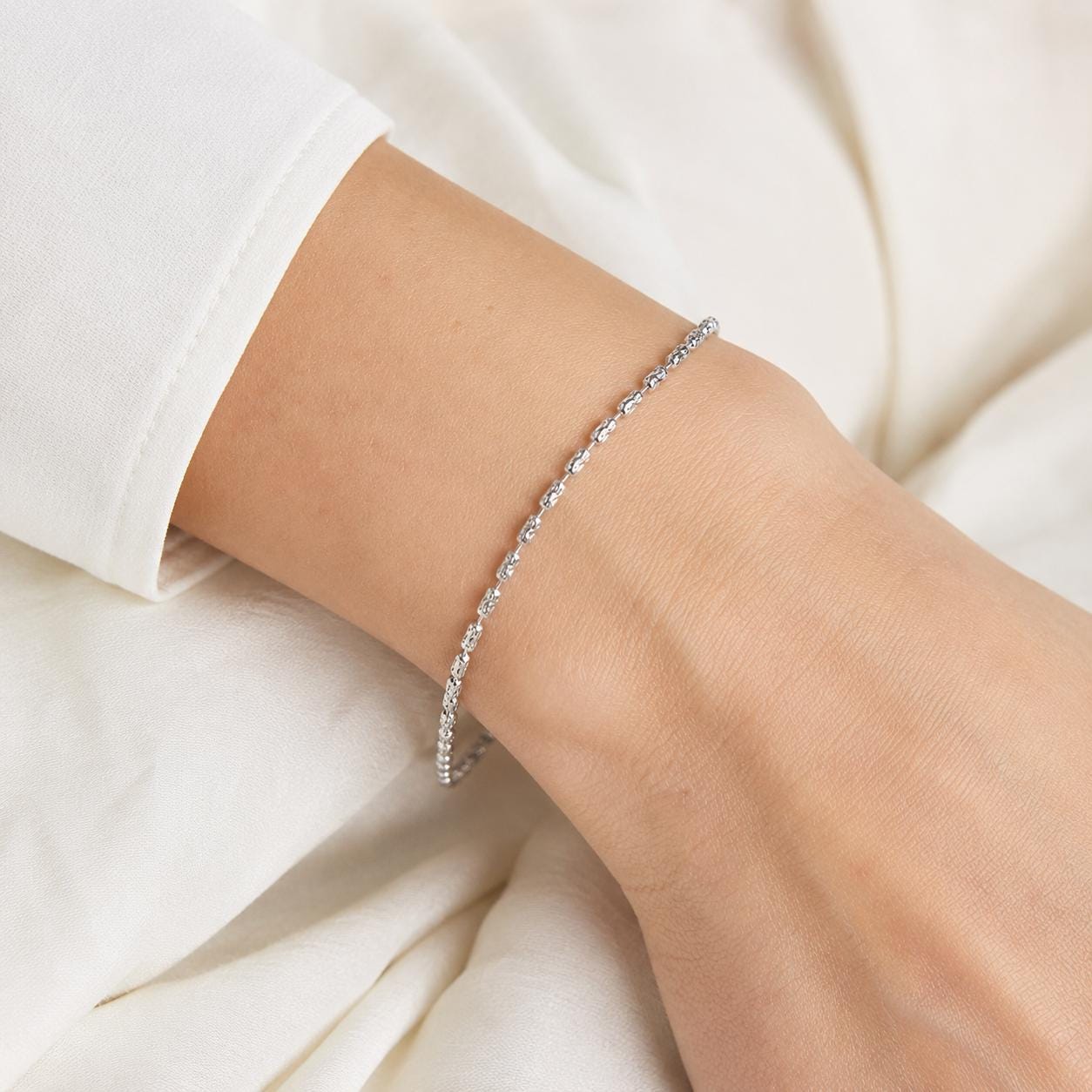 Close wrist view of textured PT950 ripple-link bracelet