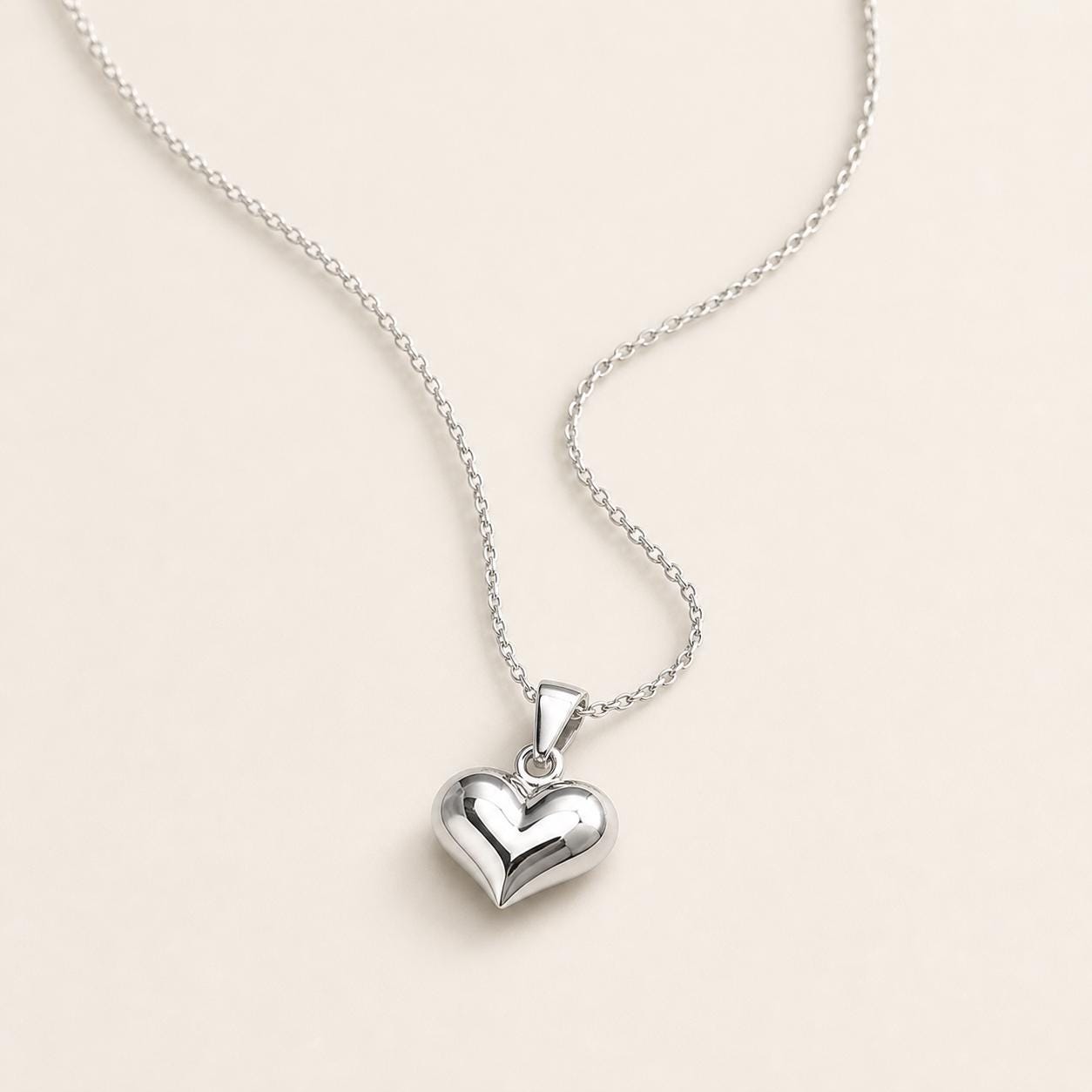 PT950 platinum heart pendant necklace arranged on an ivory background