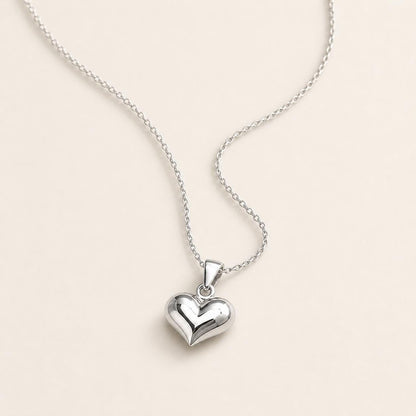PT950 platinum heart pendant necklace arranged on an ivory background