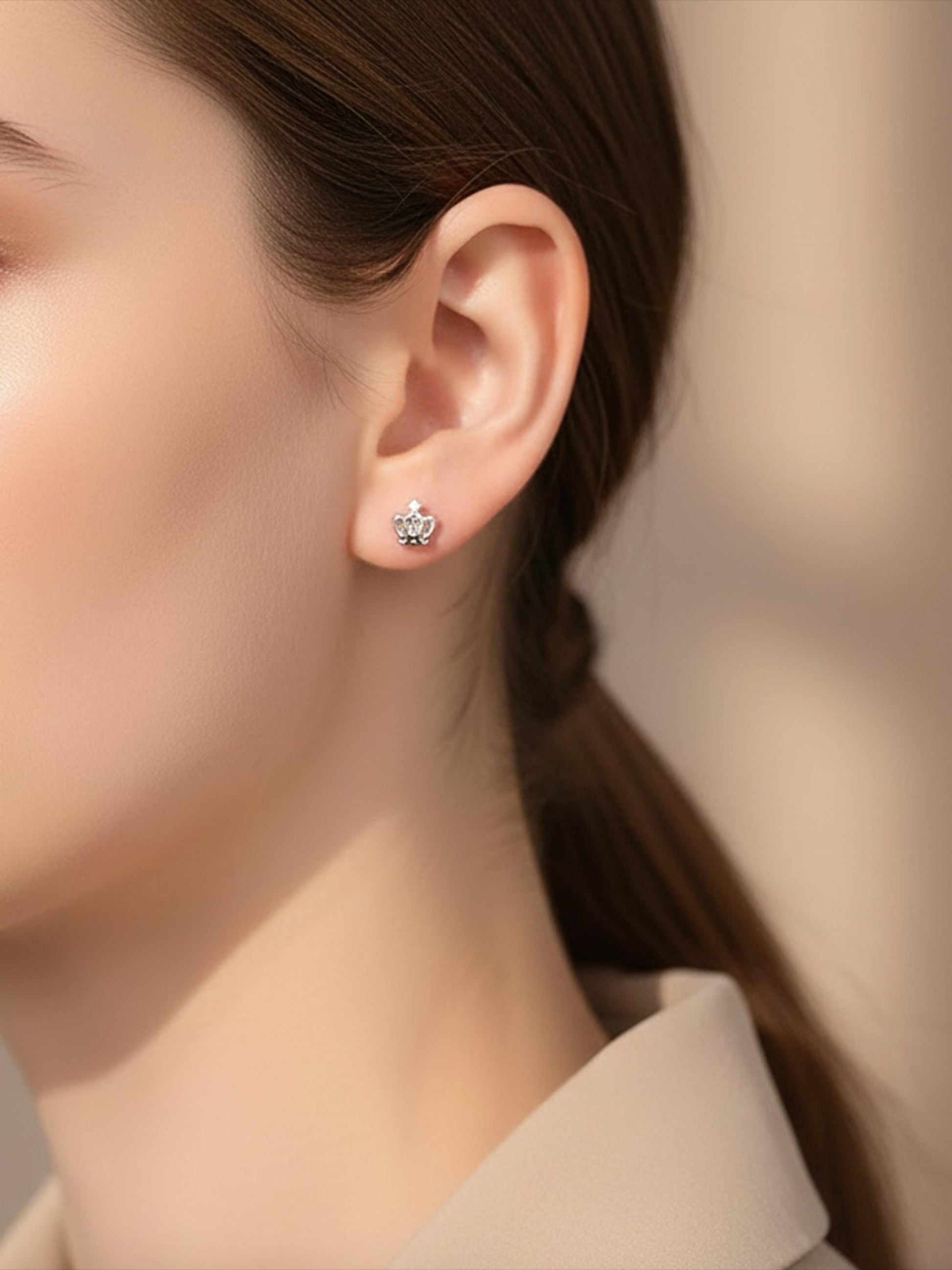 Model wearing solid PT950 platinum crown stud earrings