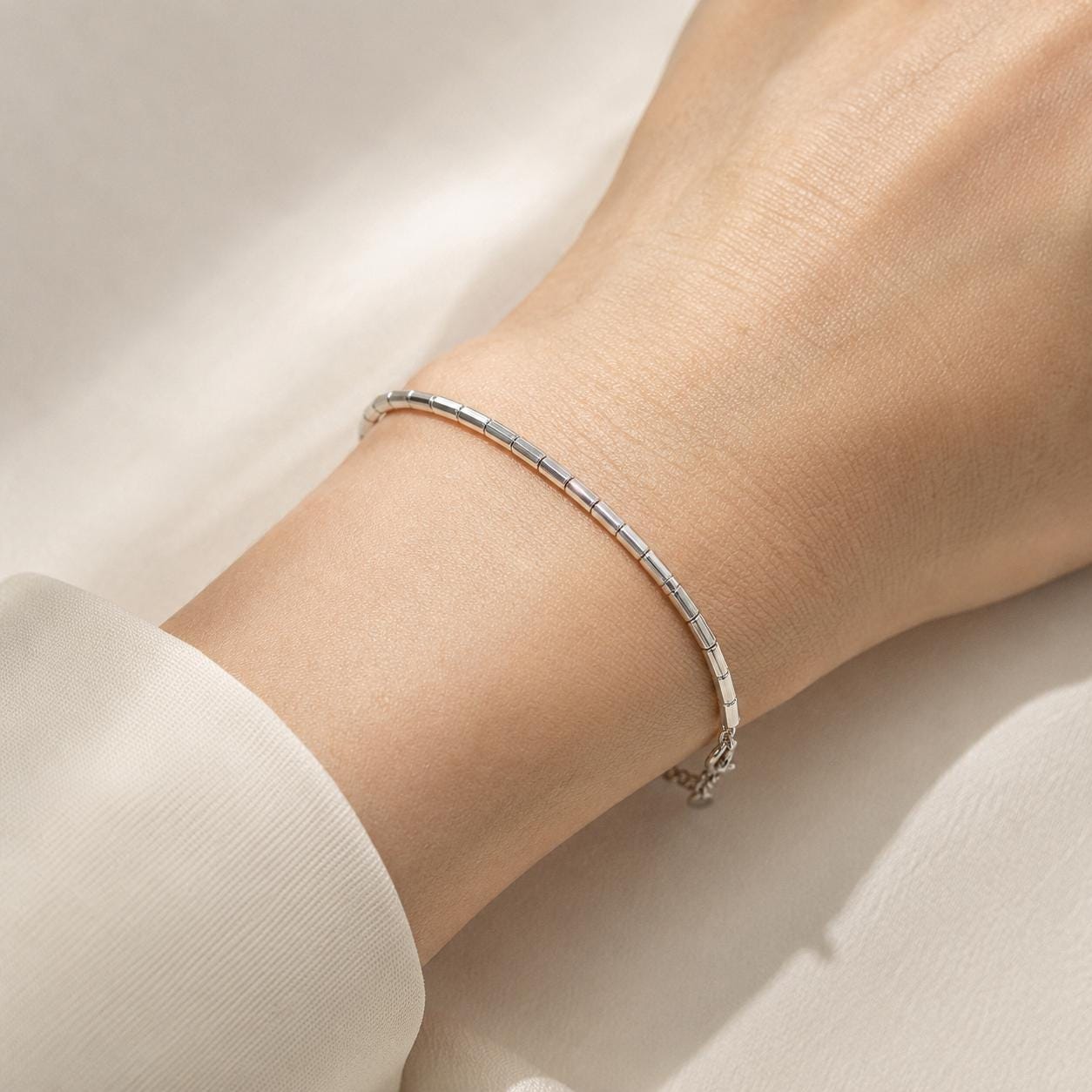 Close wrist view of adjustable PT950 barrel-link bracelet