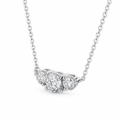 Angled detail of platinum prong settings on three-stone diamond pendant