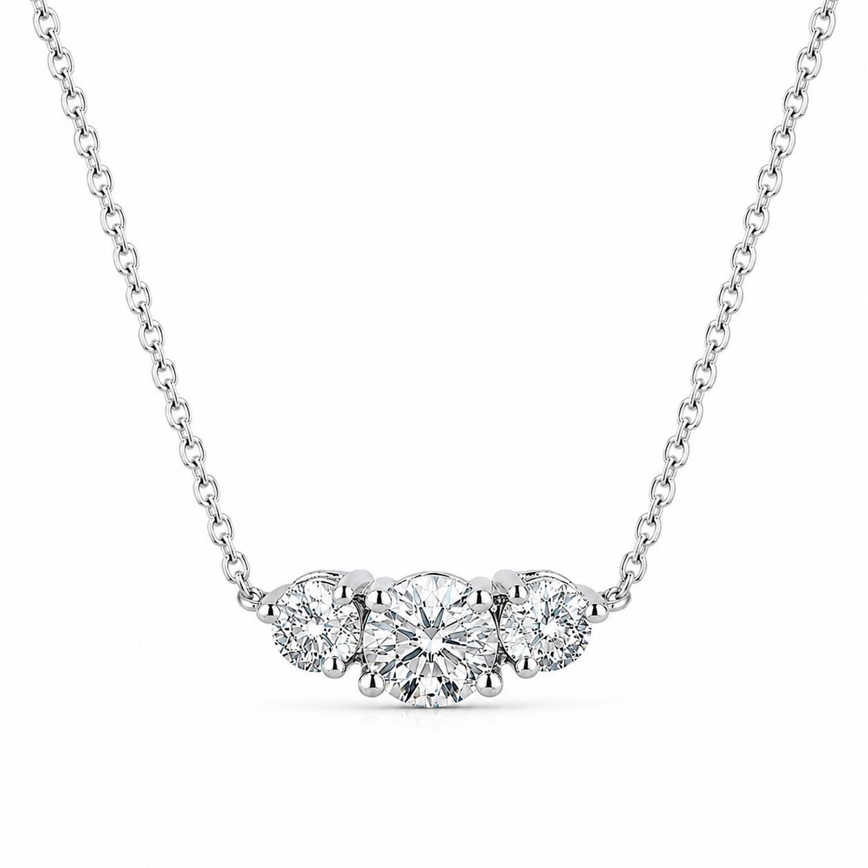Platinum three-stone lab-grown diamond necklace isolated on white