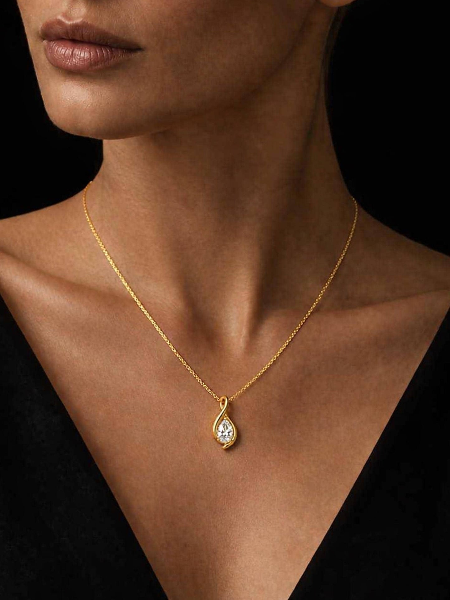 Pear lab-grown diamond necklace worn on dark skin with black neckline