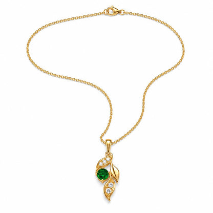 Emerald leaf necklace arranged in a flowing curve on white