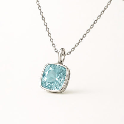 Front view of cushion blue topaz pendant with plain platinum oval bail