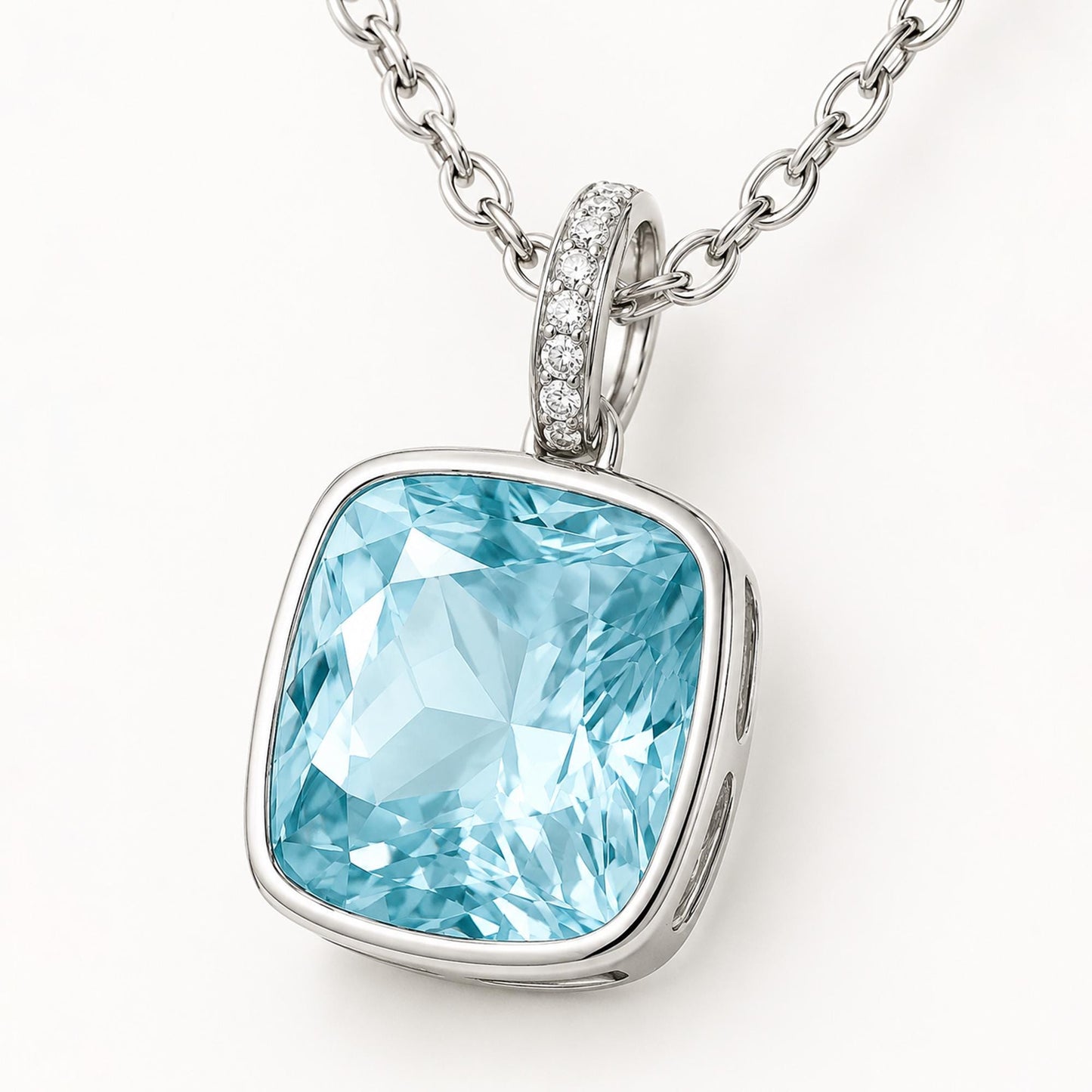 Macro detail of diamond-set platinum oval bail and blue topaz pendant