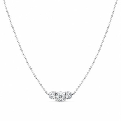 Full platinum three-stone lab diamond necklace arranged on white