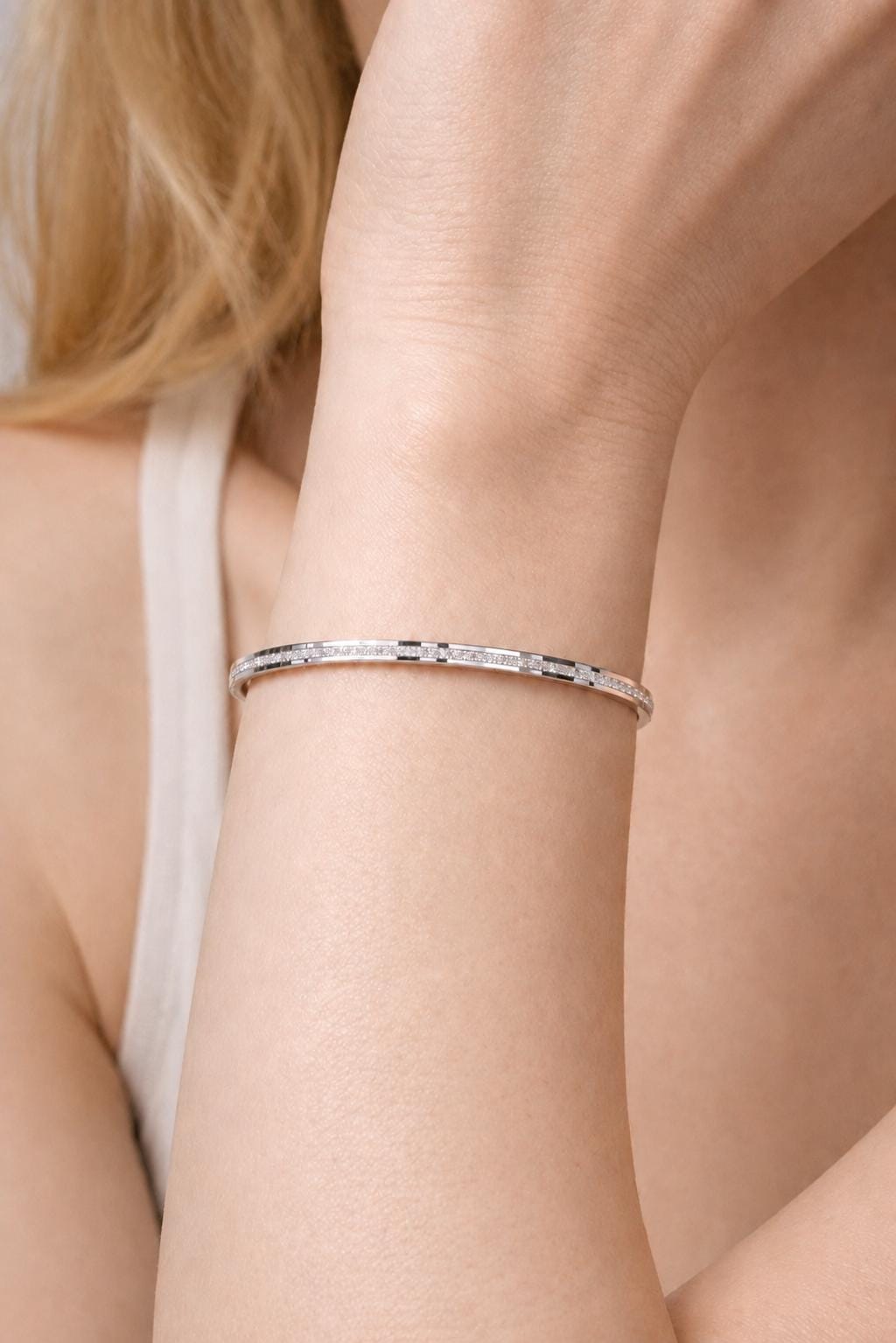 Woman wearing 3mm frosted hinged platinum bangle