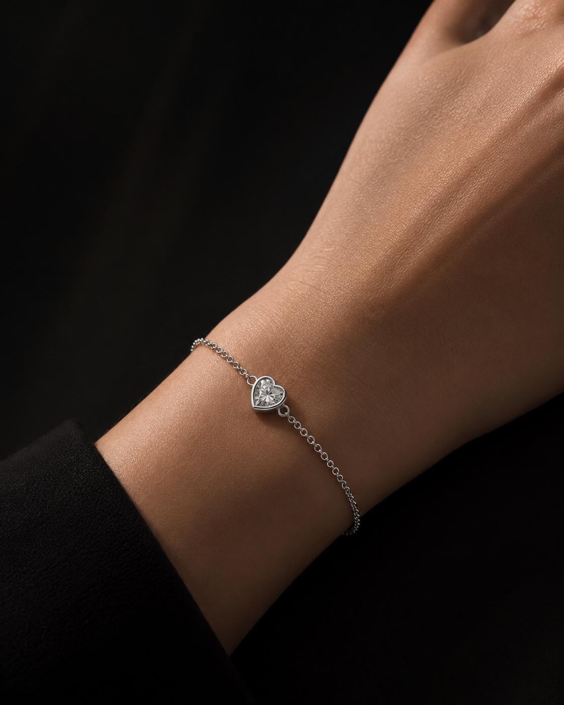 Close wrist view of platinum heart lab diamond bracelet