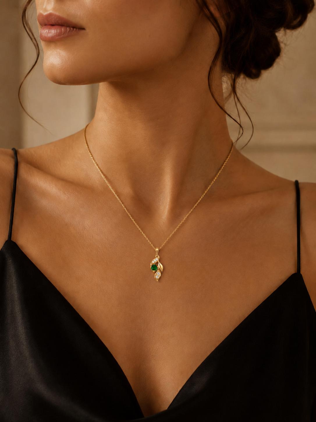 Woman wearing natural emerald leaf necklace with black satin neckline