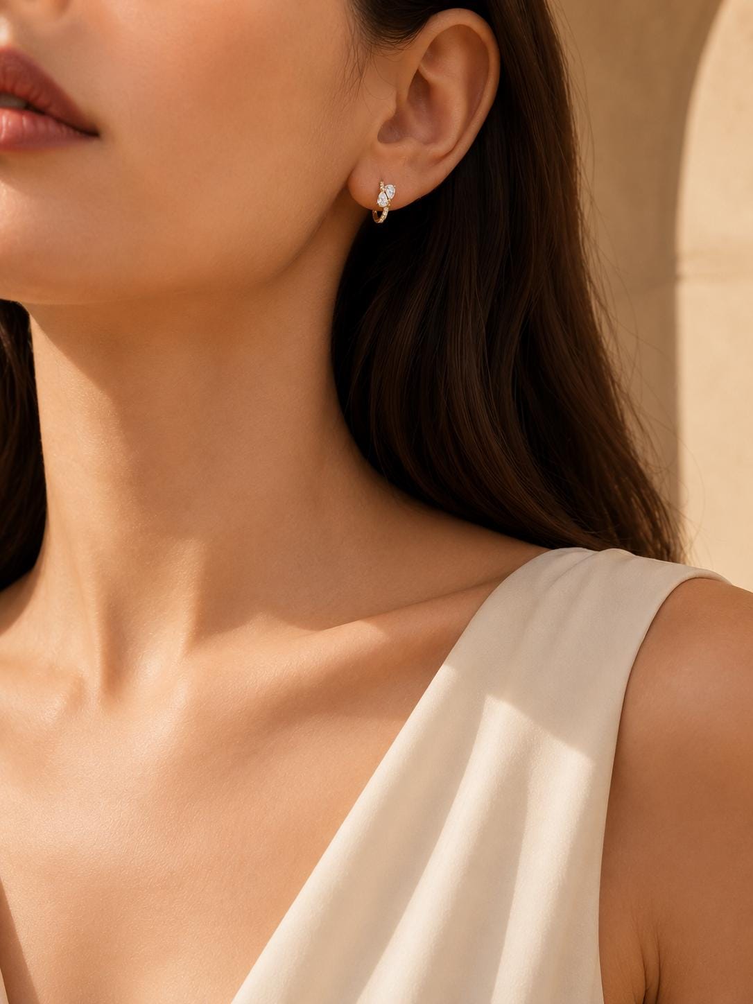 Model wearing 9mm 18K gold diamond cluster huggie earrings